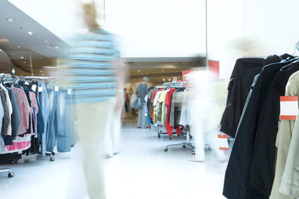 blurred customer in a clothing store