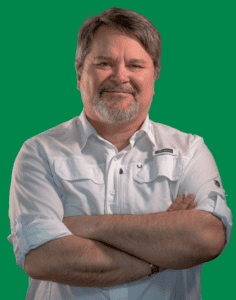 A portrait photo of Don Anderson, smiling at the camera with arms folded